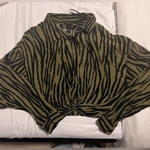 Button up shirt with knot detail in the front.